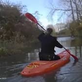 Police kayak to reach a drink-driver whose car got stuck in floodwater 