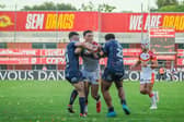 Jack Sinfield, left and Leon Ruan - seen tackling Franck Maria during Rhinos' defeat at Catalans Dragons - were both dual-registered with Halifax Panthers last weekend. Picture by Rémi Vignaud/Catalans Dragons/SWpix.com.