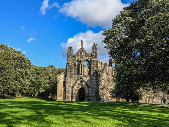 Kirkstall Abbey was founded during King Henry II's reign by a group of Catholic monks, who made a living from keeping sheep near the building for use in the wool trade.