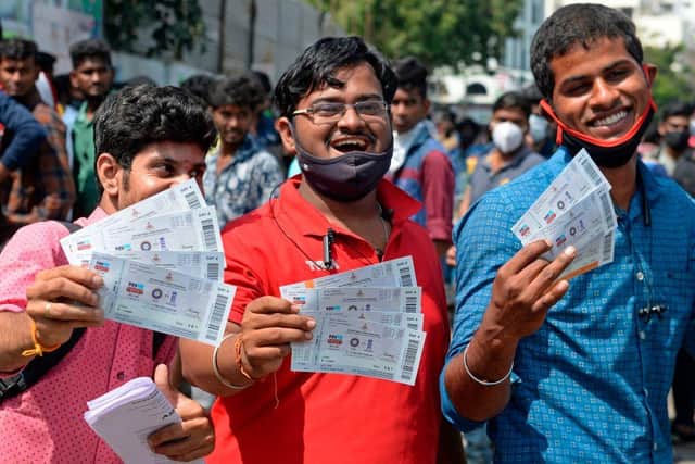 Cricket fans display tickets for the Test match between India and England. (Pic: Getty Images)