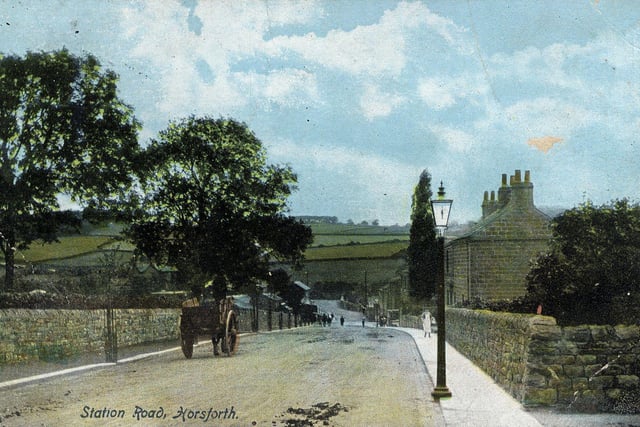 A colour-tinted postcard of Station Road looking towards Horsforth Station and bridge. A horse and cart are seen on the road. With very little development there is a good view of the hills in the background. A date of April 20, 1905 is stamped on the back of the postcard.