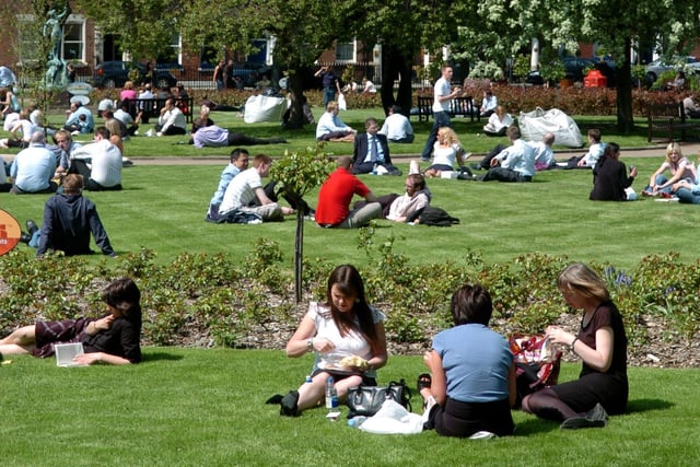 May 2006 and office workers enjoy the weather in the newly re-opened Park Square in the city centre.