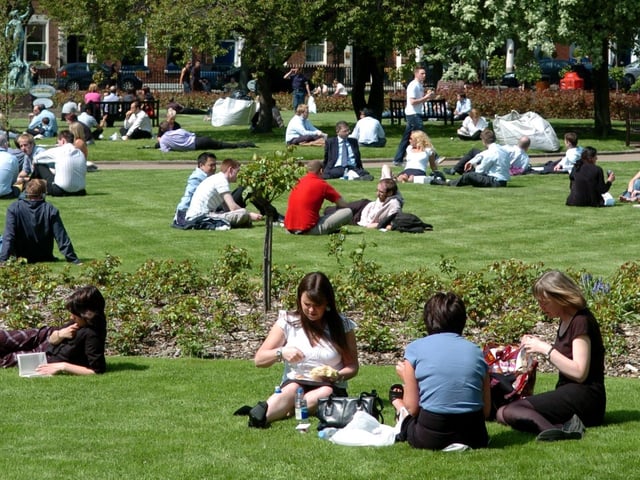May 2006 and office workers enjoy the weather in the newly re-opened Park Square in the city centre.