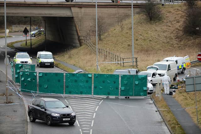 Police forensics officers examine a silver Audi with bullet holes in its windscreen near junction J24 of the M62, where Mohammed Yassar Yaqub was shot (Photo by Christopher Furlong/Getty Images)