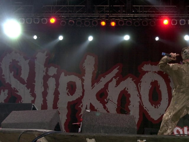 Slipknot on stage at Temple Newsam at the first ever Leeds Festival. The band is well known for its attention-grabbing image, aggressive style of music, and energetic and chaotic live shows.