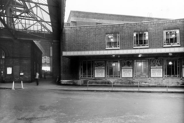 A view of the side entrance to Leeds City Station yard and Queen's Hotel. Notices can be seen advertising times of various trains. Pictured in August 1957.