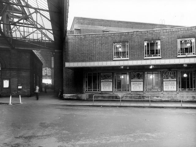 A view of the side entrance to Leeds City Station yard and Queen's Hotel. Notices can be seen advertising times of various trains. Pictured in August 1957.