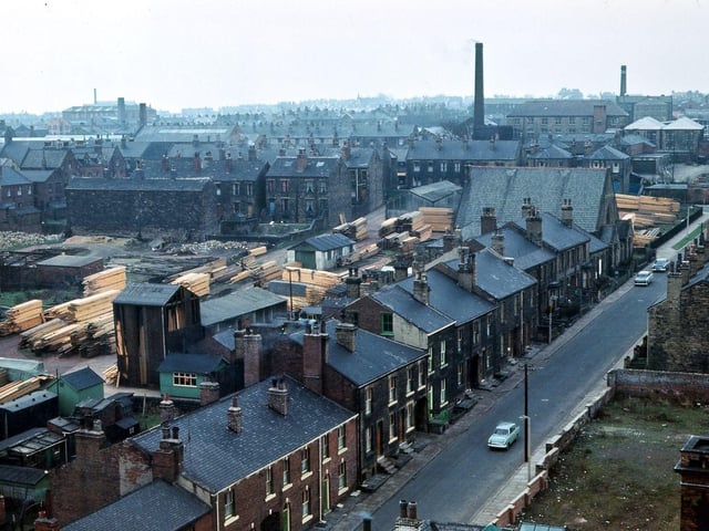 A view looking south-west across Albion Street from the tower of Morley Town Hall one Sunday morning. In the bottom right-hand corner is the hose tower from the old Morley Fire Station, and, above that, spare land where some buildings of the Queens Mill have been cleared away. A back-to-back stone terrace is beyond this. On the opposite side of Albion Street are various designs of brick and stone terraces which were cleared under slum demolition in 1972.