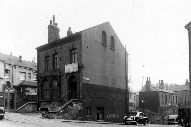On the left edge of this view is the side of the Park Hotel at number 82 Hyde Park Road with number 80 seen towards the centre which has a sign above the door which says 'Lightweight Cycle Builders, enamelling, dust proofing, shotblasting'. Spring Grove runs to the right edge. Included in the Burley slum clearance and redevelopment programme.