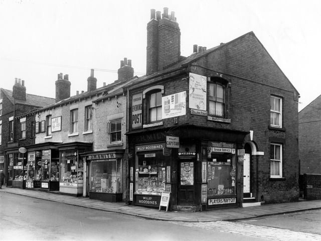 Hillidge Road seen from the junction with Hillidge Street in July 1961. The shops are, from the left: A. Senior, dispensing chemist, W. Hawley, newsagent and tobacconist, H. Cliffe, fruiterer and florist, then J.W. Smith, painting contractor and finally E.H. Milne, confectioner, newsagent and tobacconist.
