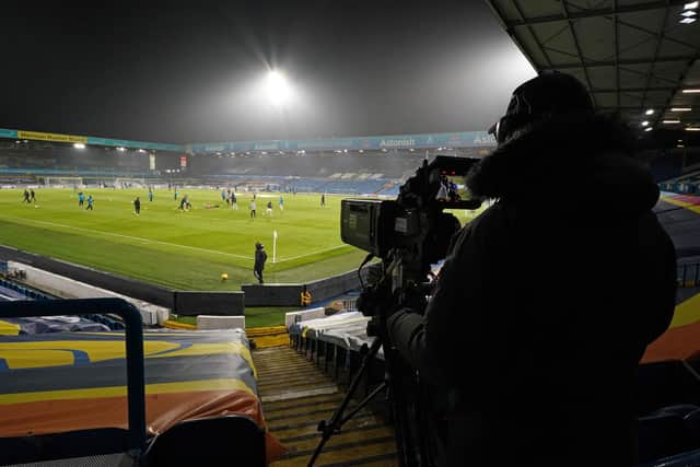 TV cameraman covers the warm up ahead of the English Premier League football match between Leeds United and Everton at Elland Road in Leeds, northern England on February 3, 2021. (Photo by Jon Super / POOL / AFP) / RESTRICTED TO EDITORIAL USE. No use with unauthorized audio, video, data, fixture lists, club/league logos or 'live' services. Online in-match use limited to 120 images. An additional 40 images may be used in extra time. No video emulation. Social media in-match use limited to 120 images. An additional 40 images may be used in extra time. No use in betting publications, games or single club/league/player publications. /  (Photo by JON SUPER/POOL/AFP via Getty Images)