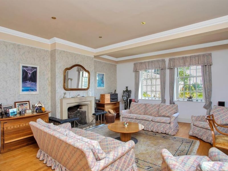 The drawing room is an impressive room with a bar and a garden room at one end.