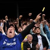 LEEDS, ENGLAND - SEPTEMBER 12: A Leeds United fan sings as the teams walk out during the Premier League match between Leeds United  and  Liverpool at Elland Road on September 12, 2021 in Leeds, England. (Photo by Laurence Griffiths/Getty Images)