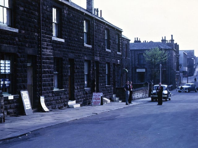 Polling Day in May 1965 opposite the Baptist schoolroom in Albion Street where the Committee rooms for both the Labour candidate (Frank Tighe) and the Conservative candidate (Ian Baird) were situated. There is a view right along Albion Street to the saw-tooth roof of Field Mill in the distance. Three of the Labour councillors or candidates are standing in the street and Dr. De Keyser's Rolls Royce is rounding the corner on to Commercial Street. The houses which are the committee rooms were demolished about 1972.