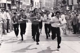 Shopping in Leeds city centre came to a standstill in June 1986 as a group of waiters showed their racing skills. The first ever Leeds waiters' race, a curtain raiser to the Lord Mayor's Parade was started by Miss Leeds Metro '86 Julie Garnett from Commercial Street and finished under three minutes later outside the Bistro Fiori. Mark Hatton, a waiter at the Queens Hotel, was first across the finishing line with his tray, bottle of bubbly, glass and ashtray intact. He received a cheque for £100 from the Bistro Fiori.