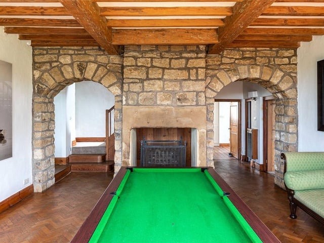 Further ground floor accommodation includes a guest WC, alongside a separate family room which again displays exposed timber beams and fireplace.
