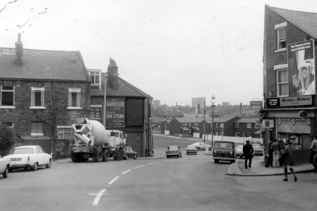 Looking south along Hyde Park Road/Woodsley Road towards Burley Road in August 1975. On the right, by the junction with Burley Lodge Terrace, is K. Barker, newsagent, at no.7 Hyde Park Road. On the left, the building in the foreground is Andrew Commercial Hotel, no.130 Burley Road; behind this is Smith's Cafe at no.134. An advertisment for Alf Harrison, Ladies Hair Styling, can be seen.
