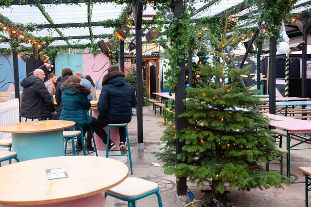 Christmas trees and festive arrangements pictured, as revellers can be seen enjoying the Winter Village at Chow Down, Temple Arches, Leeds.