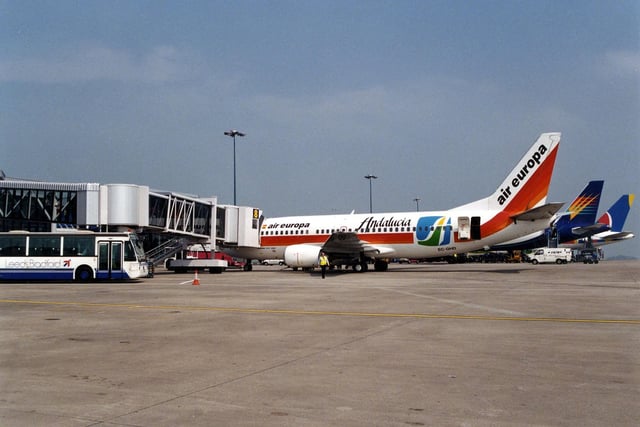 The airfield at Leeds Bradford Airport with three aeroplanes, including an Air Europa, in view. A bus and other vehicles are also visible. This photo was taken sometime in the summer of 1996.