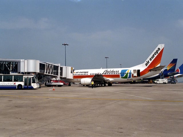 The airfield at Leeds Bradford Airport with three aeroplanes, including an Air Europa, in view. A bus and other vehicles are also visible. This photo was taken sometime in the summer of 1996.