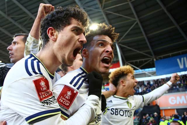 NO BETTER WAY: Sonny Perkins, left, celebrates netting his first goal for Leeds United and first in professional football in front of a packed away end at Cardiff City. 
Photo by GEOFF CADDICK/AFP via Getty Images.