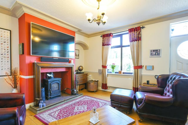 The property has a spacious lounge with a feature fireplace with a log burner.