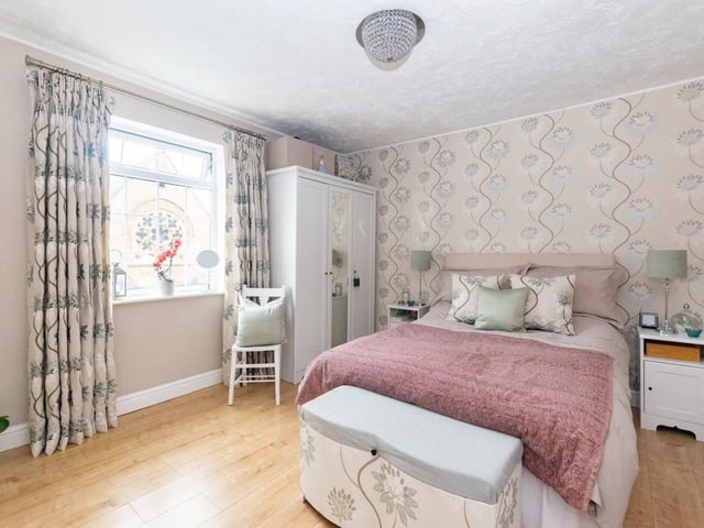 The master bedroom has ample space and features a built-in wardrobe.