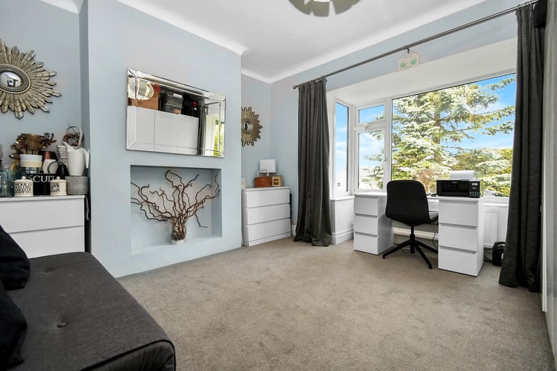 Currently used as a sitting room and home office, this space could also be set up as a fourth bedroom.