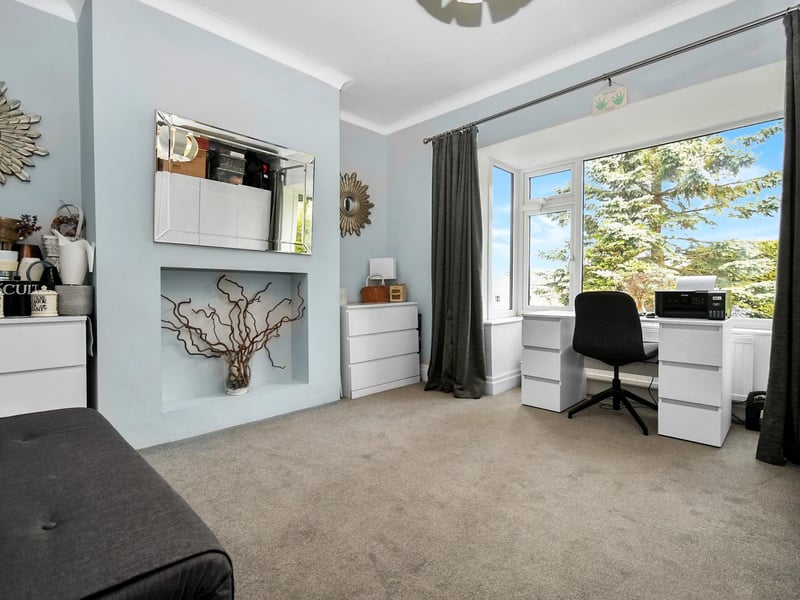 Currently used as a sitting room and home office, this space could also be set up as a fourth bedroom.