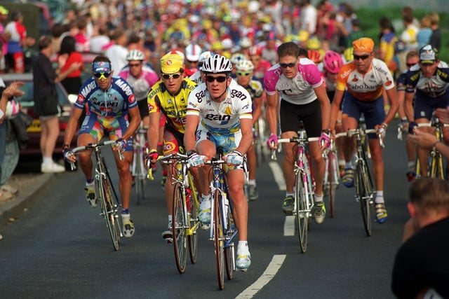 Cyclist Chris Boardman leads the peloton up out of Ilkley past the Cow and Calf in August 1996.
