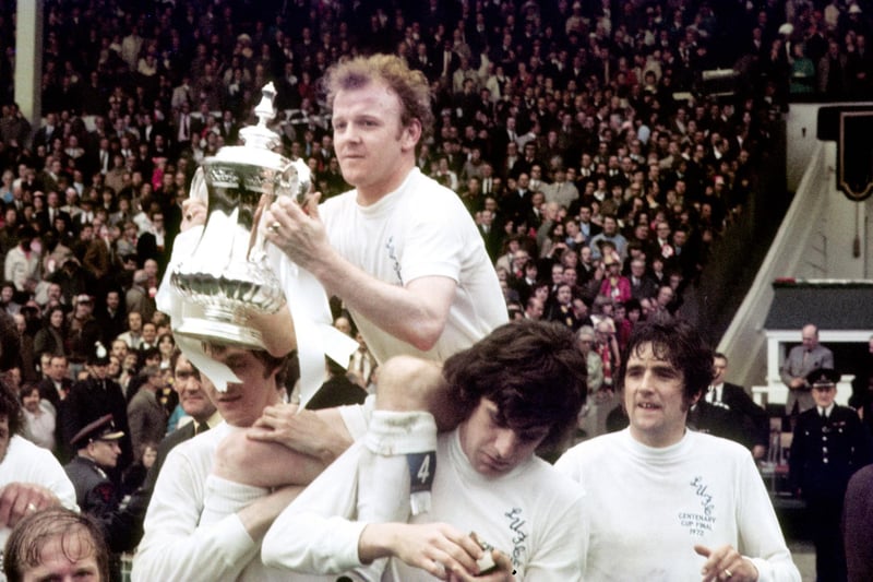 Billy Bremner is pictured holding the FA Cup at Wembley in May 1972 while Peter Lorimer checks his medal.