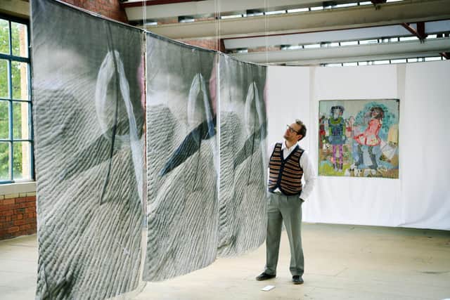 John Gaunt views work on show by the 62 Group of Textile Artists, in the Touchlines in Sunny Bank Mills. Picture: Jonathan Gawthorpe.