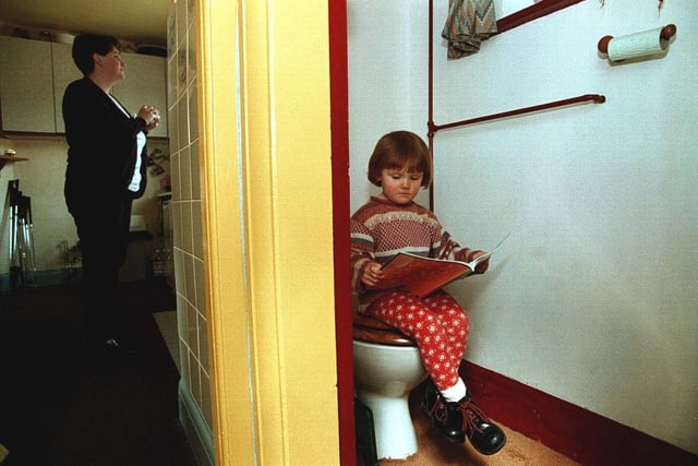 While mum Dawn Goodyear gets on with the dinner, daughter Tori uses the family's outside loo to have a quiet read. The Goodyear's was the last house in Wetherby to have an outside toilet in April 1998. But the council was set to install an upstairs bathroom, so no more midnight trips downstairs.