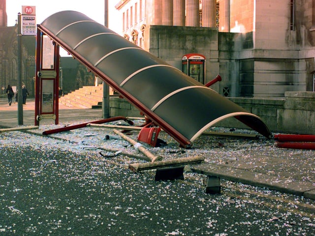 Glass from a bus stop covers the road of Woodhouse Lane in front of the University of Leeds after a car crashed into it in February 1999.