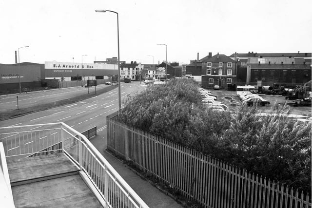 E J Arnold and Sons, printers, who had factory on the site of John Fowler and co., Steam Engine works. Now Costco warehouse has replaced this factory. To the right of the print works is the Mulberry public house. The area to the right was utilised by WASS garage for car parking space. Pictured in March 1980.