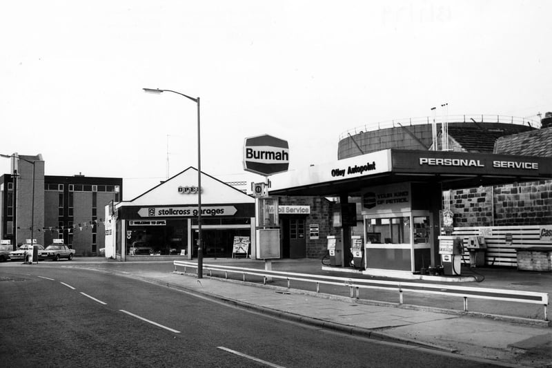 Gay Lane showing Otley Autopoint Petrol Filling Station in July 1979. Beside this is the junction with Wellcroft, with Stollcross Garages car showroom beyond. In the background on the right, a gasometer can be seen.