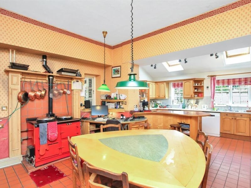 At the centre of the house is the kitchen, which includes space for dining along with an adjacent utility room and office.