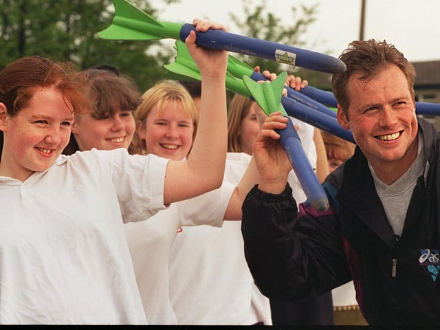 International javelin thrower Mick Hill visited his old school, Ralph Thoresby High to give lessons as part of his job as Leeds Sports Development, assistant athletics officer in June 1996.  He is pictured explaining technique, using safety javelins with Gemma Hill. (no relation)