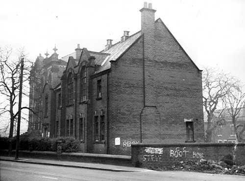 A side view of a large building with broken windows once the premises of the Boy's Brigade (27th Leeds Company). Pictured in December 1972.