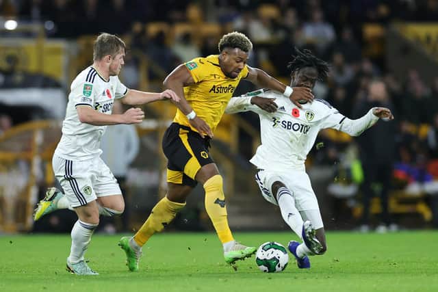 WOLVERHAMPTON, ENGLAND - NOVEMBER 09: Adama Traore of Wolverhampton Wanderers is challenged by Darko Gyabi and Kristoffer Klaesson of Leeds United during the Carabao Cup Third Round match between Wolverhampton Wanderers and Leeds United at Molineux on November 09, 2022 in Wolverhampton, England. (Photo by David Rogers/Getty Images)