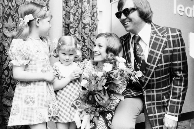The Spencer sisters -  Katie and Sally- from Middleton present flowers to singers Peters and Lee at the Schofields store in May 1976.