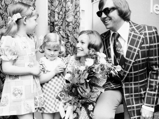 The Spencer sisters - Katie and Sally- from Middleton present flowers to singers Peters and Lee at the Schofields store in May 1976.