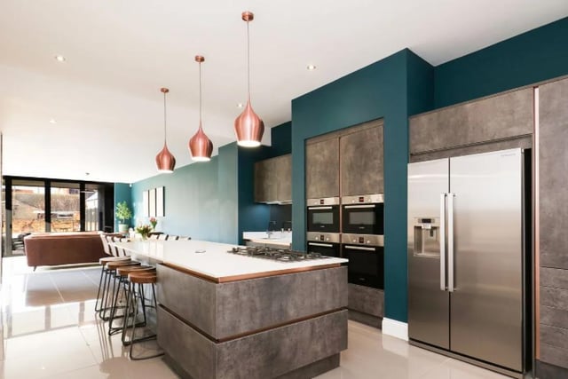 The house's ultra-modern kitchen isn't dull or boring like some contemporary dining rooms - it's full of quirky decor and design choices.