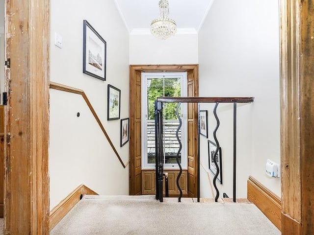 An open staircase leads up to the first floor landing and the bedrooms.
