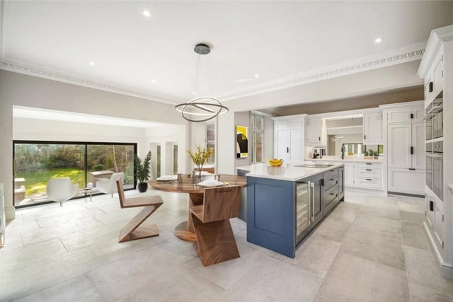 The high spec spacious kitchen with island includes four Miele ovens comprising two of full size, a microwave combination and a steam oven. There's a boiling tap by Quooker and a large American-style Fisher and Paykel refrigerator with built in ice dispenser among the appliances.