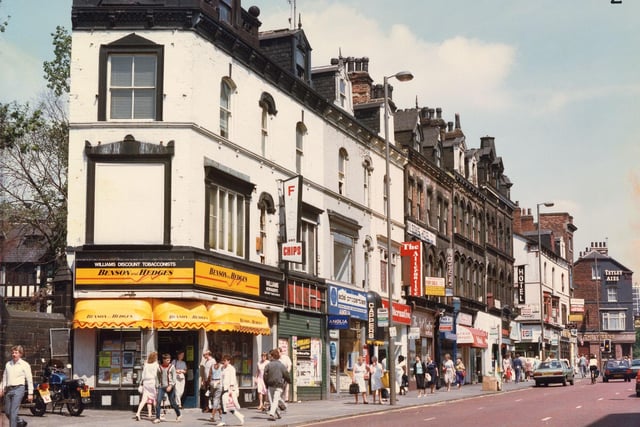 New Briggate in July 1986. Shops to be seen include Williams' newsagent and tobacconsts, Adel Properties estate agents, The Alternative restaurant and take-away, The Art Centre, Wilson Hotel (displaying a for sale sign), Sultan's Kebab House, In Tone art materials and Le Carousel restaurant. The Wren's public house is on the right, at the junction with Merrion Street.