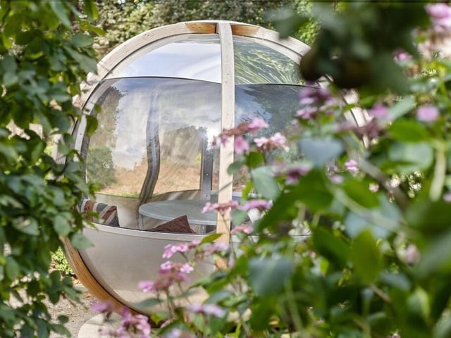 A stylish garden pod provides a sheltered spot to relax and enjoy the outdoors.