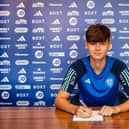 THRIVING: Seventeen-year-old Leeds United midfielder Charlie Crew, pictured signing his first pro contract with the Whites earlier this summer.