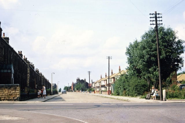 Looking down Springfield Lane from the junction with Victoria Road. The Shell filling station at the right hand corner has just been built but the corner seat is still there, the pavement is still slabs and the road sandstone setts. Only one car is parked on the street, Springfield Mills is just visible and the first two houses (one in Springfield Lane and one in Springfield Road) on the left have not yet been demolished to improve visibility.