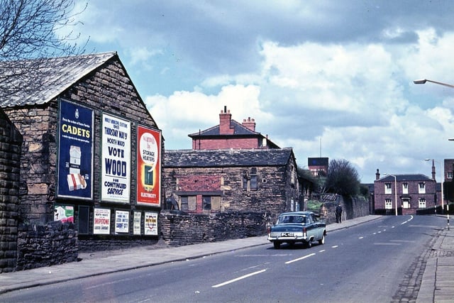 The small rise on Victoria Road between Victoria School and Providence House which is called Stubley Hill after the farmer. He worked the farm, just past the school, in the middle and late nineteenth century. Barns on either side of the farmyard can be seen, one with at least two posters referring to the local May elections of 1963. Providence House on the right hand side was built by the owner of Providence mill, Alderman Joseph Schofield who lived there until he retired.